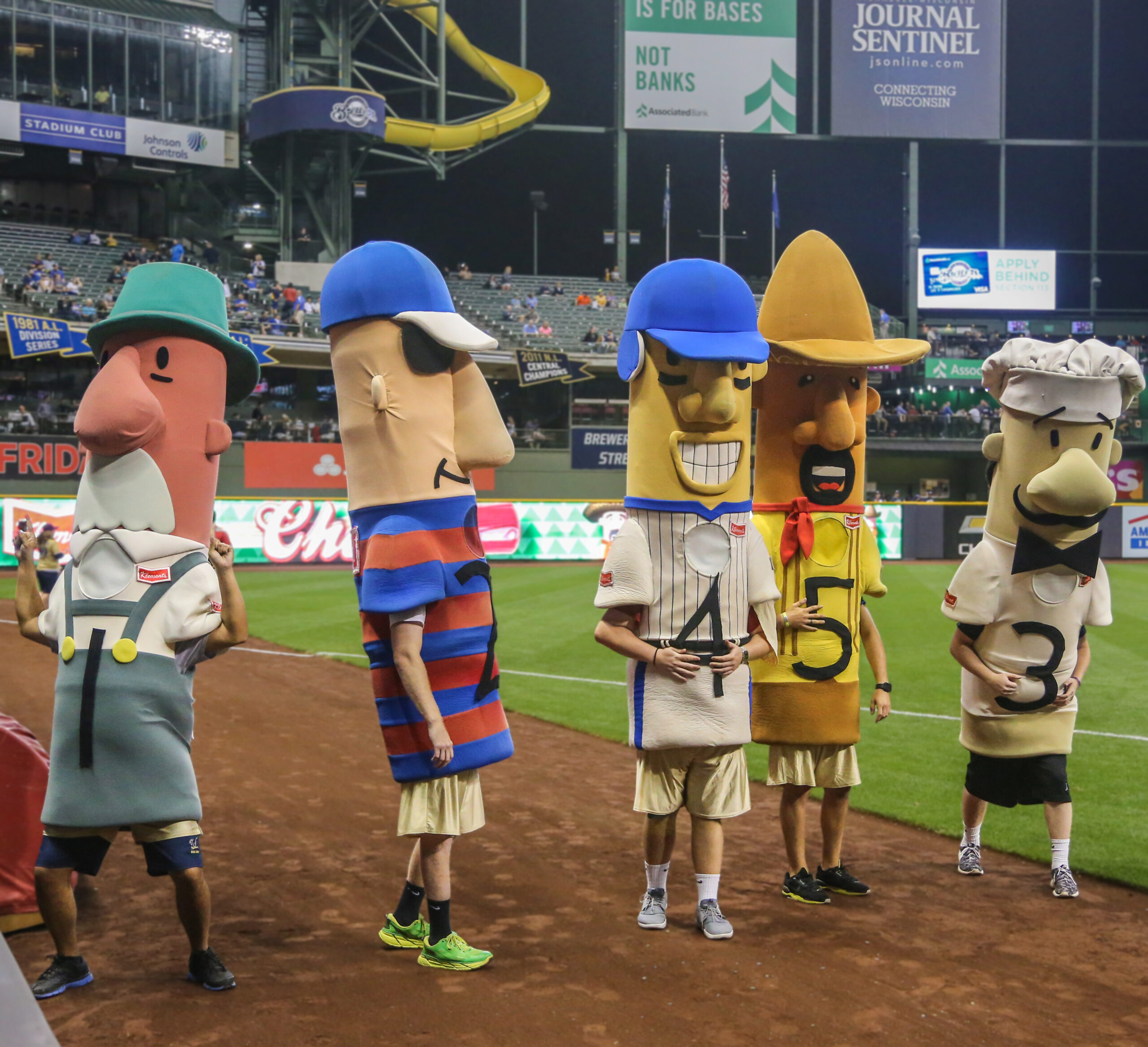Milwaukee Brewers Racing Sausages lined up on the field.