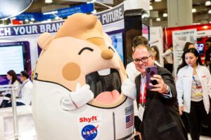 Mascot At Tradeshow Taking Selfie With Man