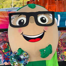 Dark blurred background photo of a soy bean mascot wearing glasses