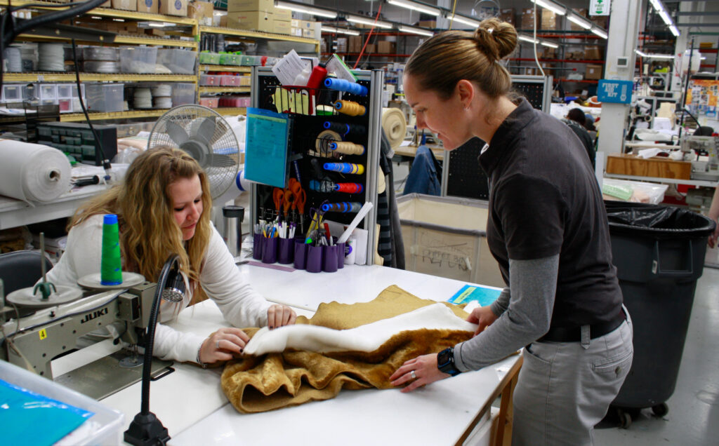 Olympus Mascot production team looking a fabric samples.