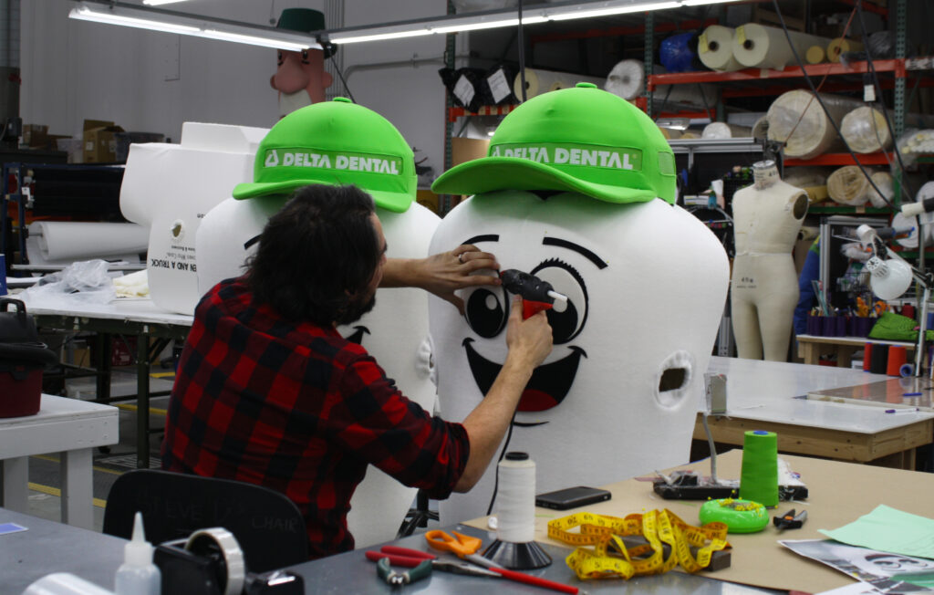 Olympus Mascot production member working on creating a tooth mascot.