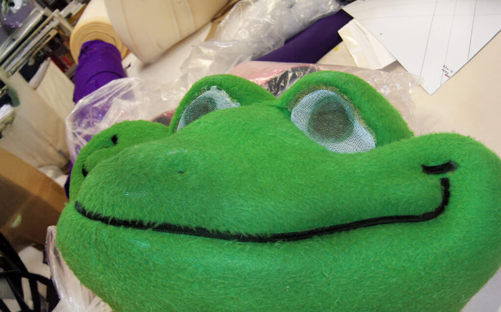 Old mascot frog head with damaged vision screens.