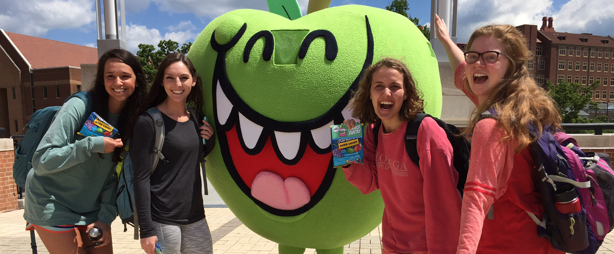 An Apple Mascot with students