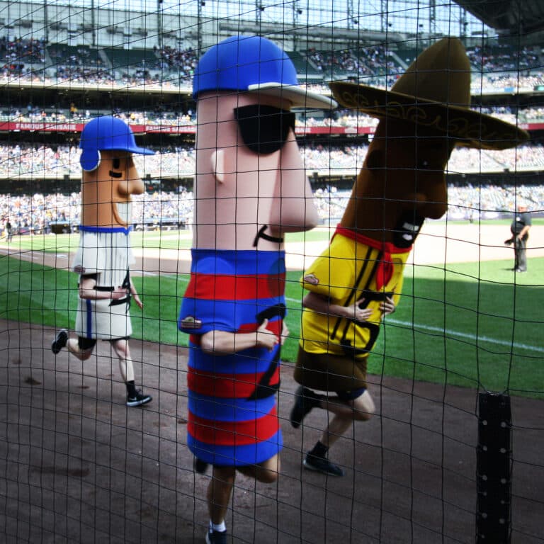 The Famous Racing Sausages running on the warning Track of Miller Park