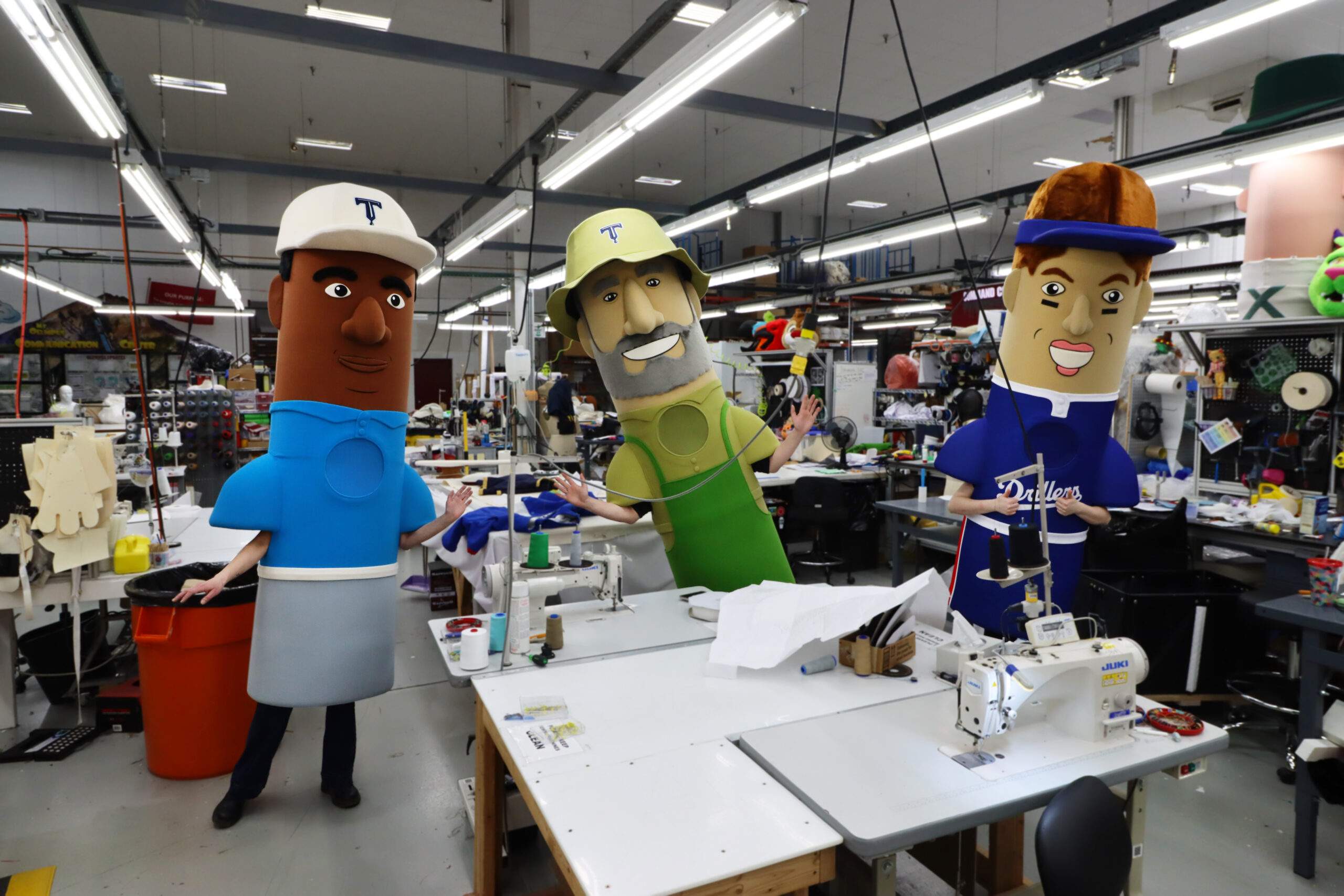 Three of the Tulsa Drillers racing mascots standing in the Olympus warehouse.
