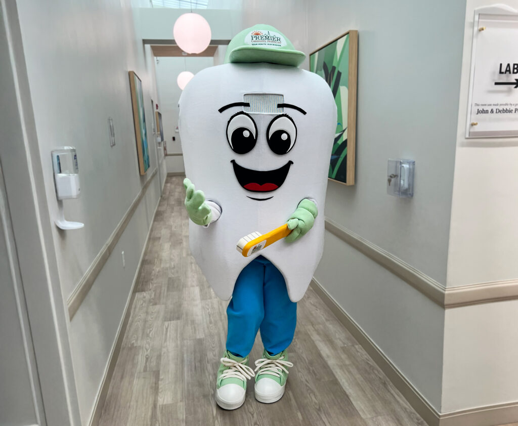 Mascot of a tooth named Dr. Flossy for Premier Health Care.