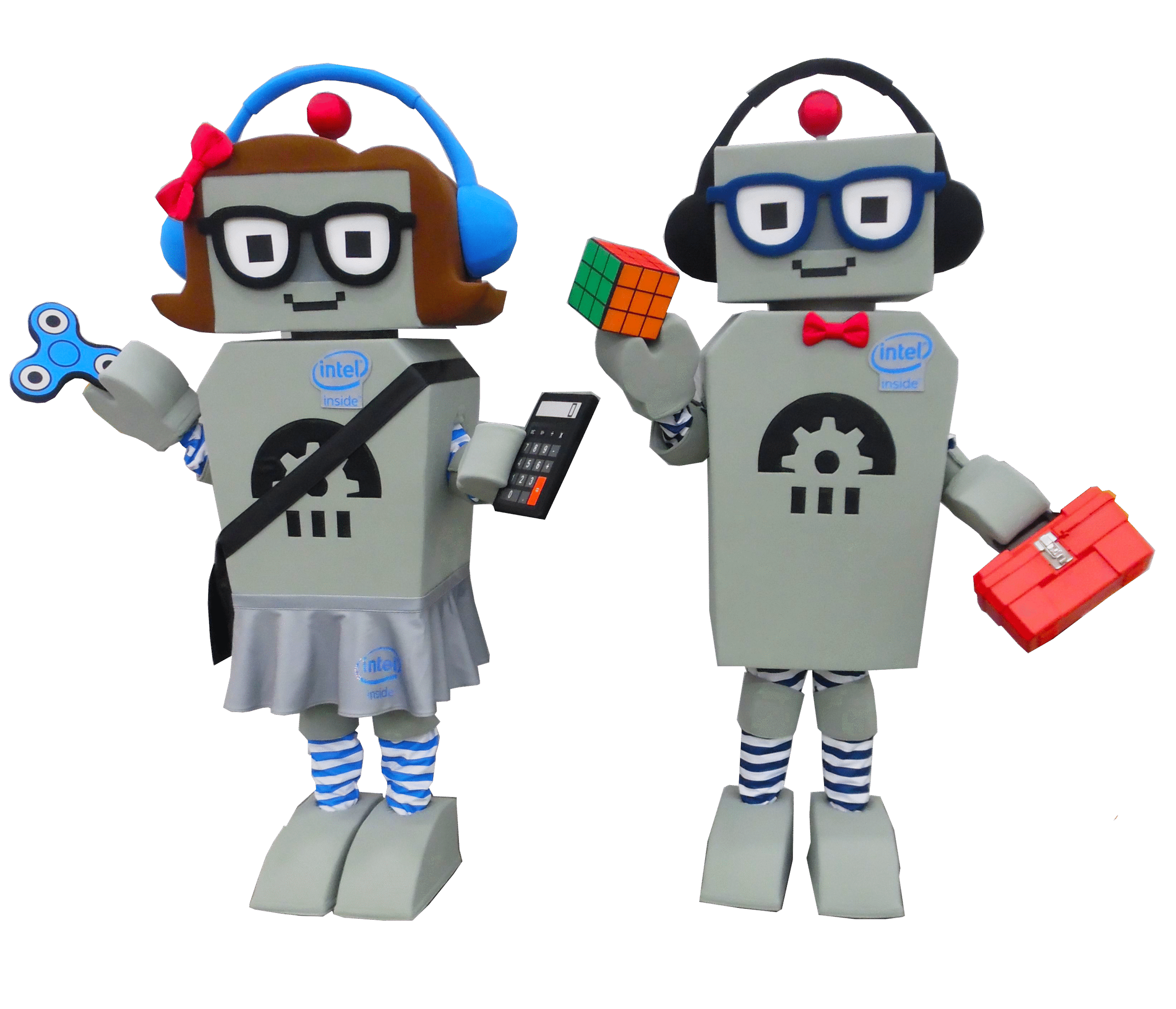 A girl and boy robot mascot for Intel posing for a photo holding all of their accessories. The girl robot is holding a fidget spinner, calculator, wearing blue headphones and wearing a sash. The blue robot is holding a Rubik's Cube, a tool box and is wearing black headphones.