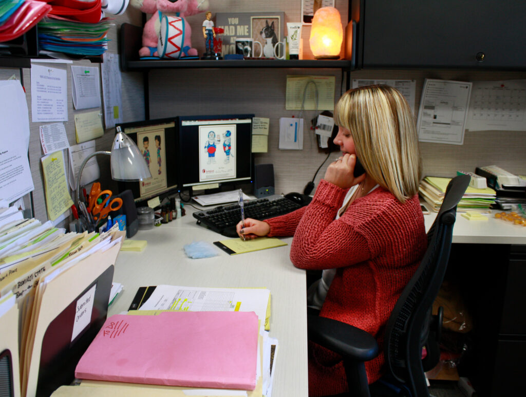 Mascot sales taking a phone call with a customer.