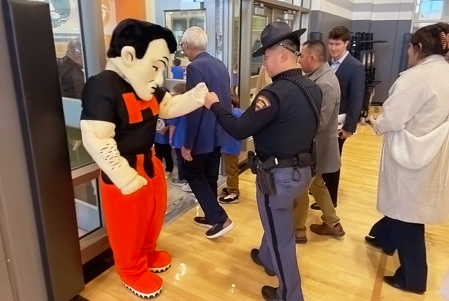 Marshman fist bumping police officer