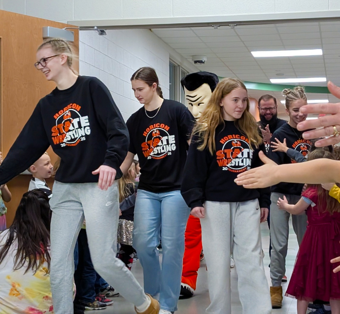 Students and Marshman Mascot participating in the Walk of Champions