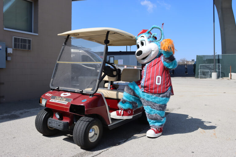 Ollie Olympus striking a pose on a golf cart near Summerfest grounds.