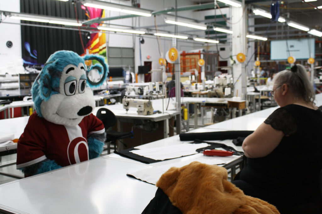 Ollie Olympus looking over designs with a sketch artist.