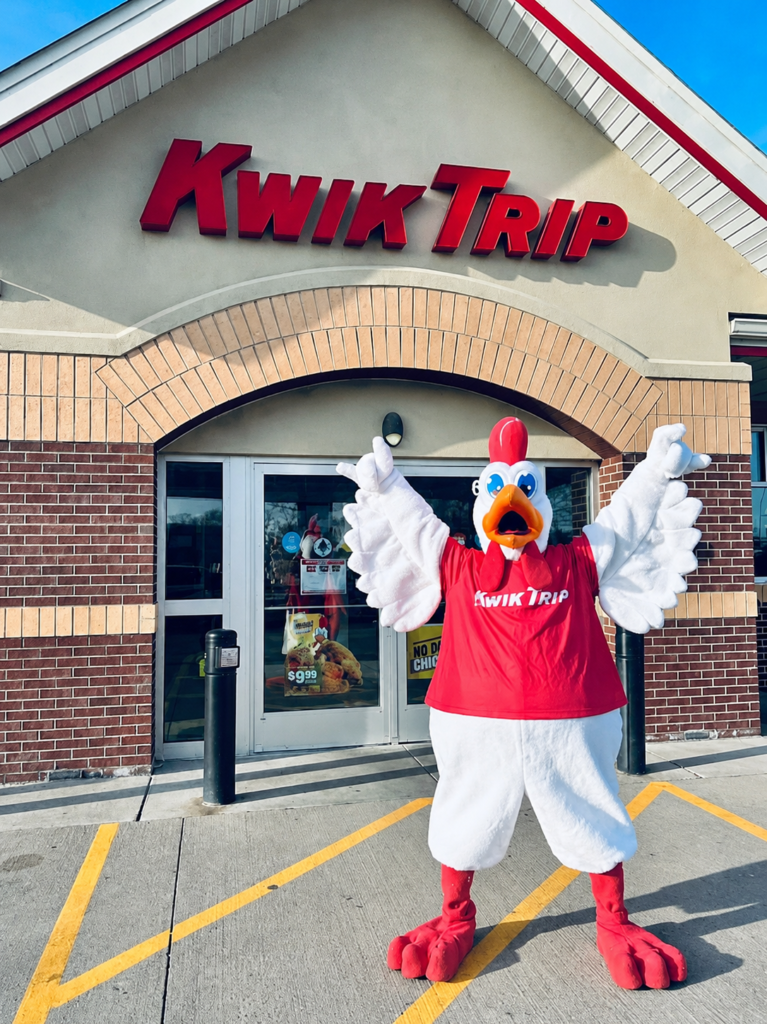 Red posing in front of a Kwik Trip store.